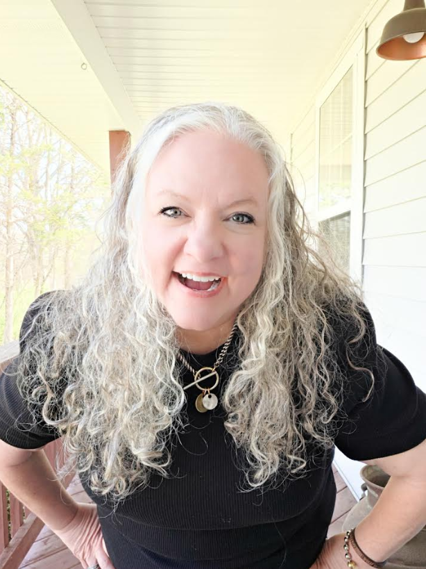 Christy smiling warmly, representing genuine wellness and authenticity