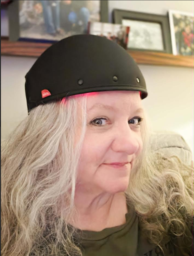 Christy wearing the medical-grade REVIAN Red Light Hair Growth Hat